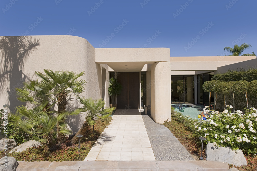 Lawn and walkway in front of a modern house against clear sky Lawn and walkway in front of a modern house against clear sky