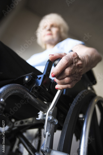 Low angle view of a blurred senior woman operating wheelchair