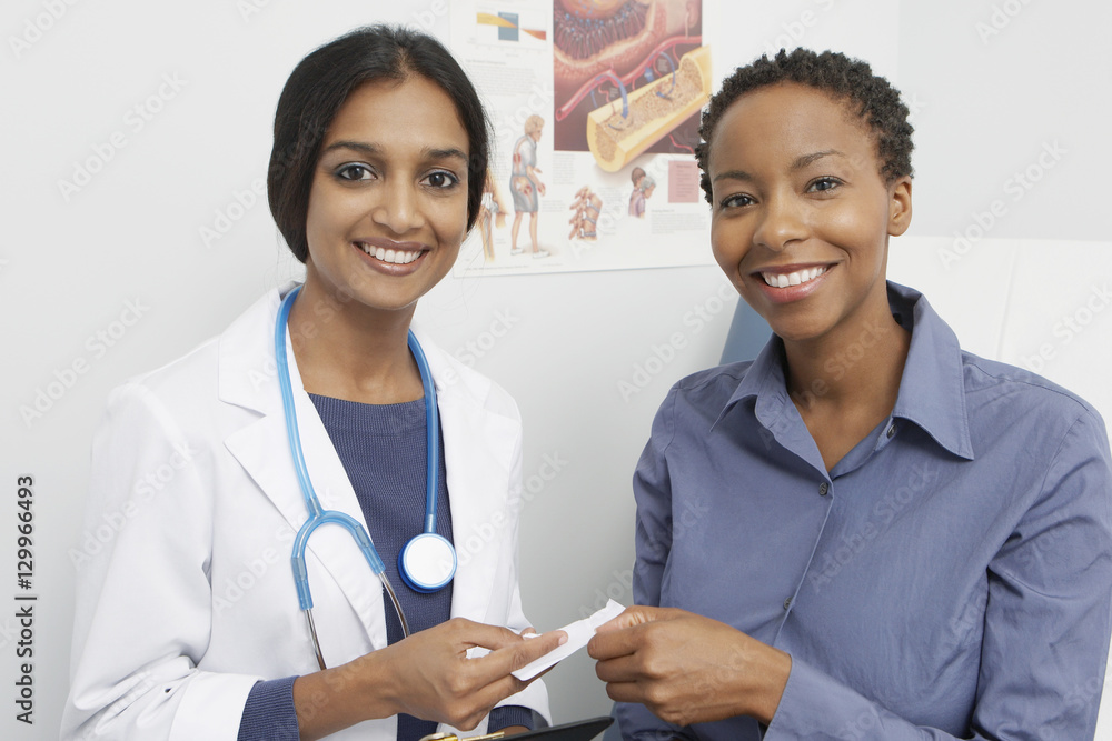 Portrait of smiling Indian female doctor and African American patient in the clinic Portrait of smiling Indian female doctor and African American patient in the clinic