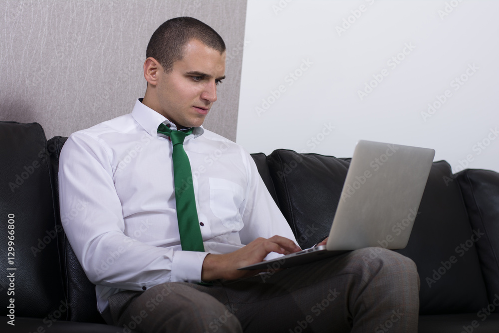 Handsome businessman working with laptop at home. Handsome businessman working with laptop at home.