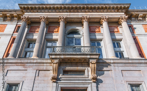 European architecture building details with Corinthian Capital columns.  European style from decades past combined with updated glass features reflected in doors and windows. 