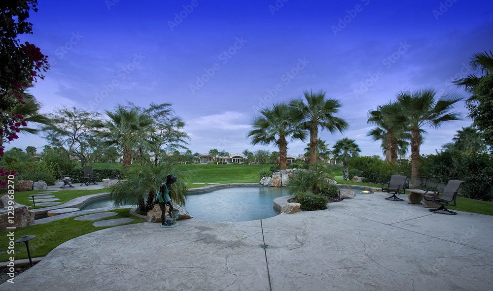 Swimming pool in the backyard of a luxury home Swimming pool in the backyard of a luxury home