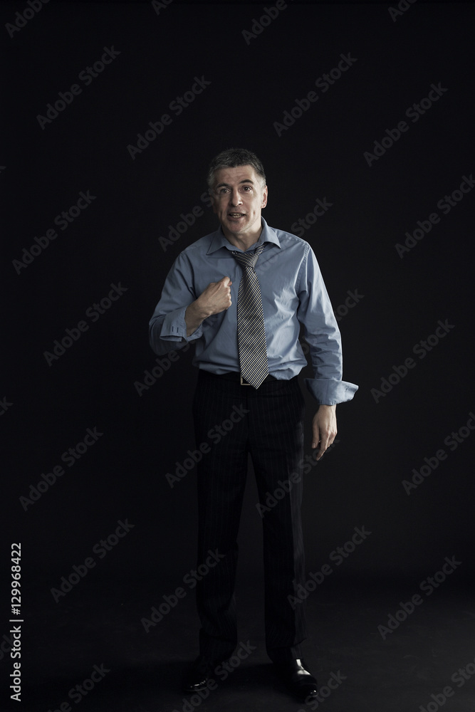 Disappointed businessman pointing finger at himself isolated over black background Disappointed businessman pointing finger at himself isolated over black background