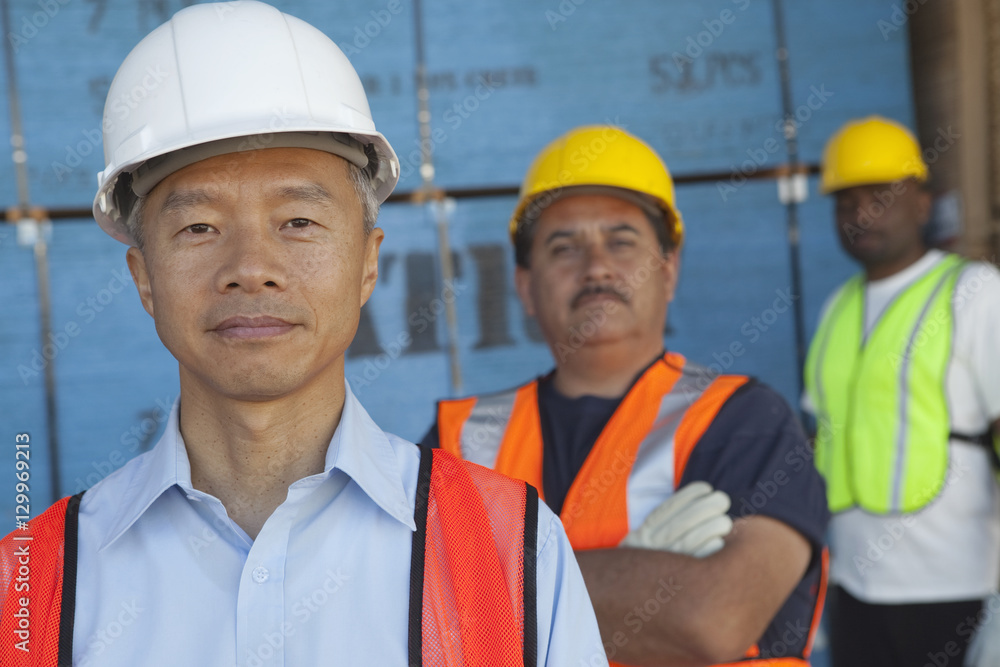 Portrait of a smiling middle-aged man with colleagues Portrait of a smiling middle-aged man with colleagues