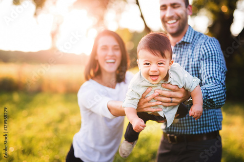 Parents having fun with their baby boy photo