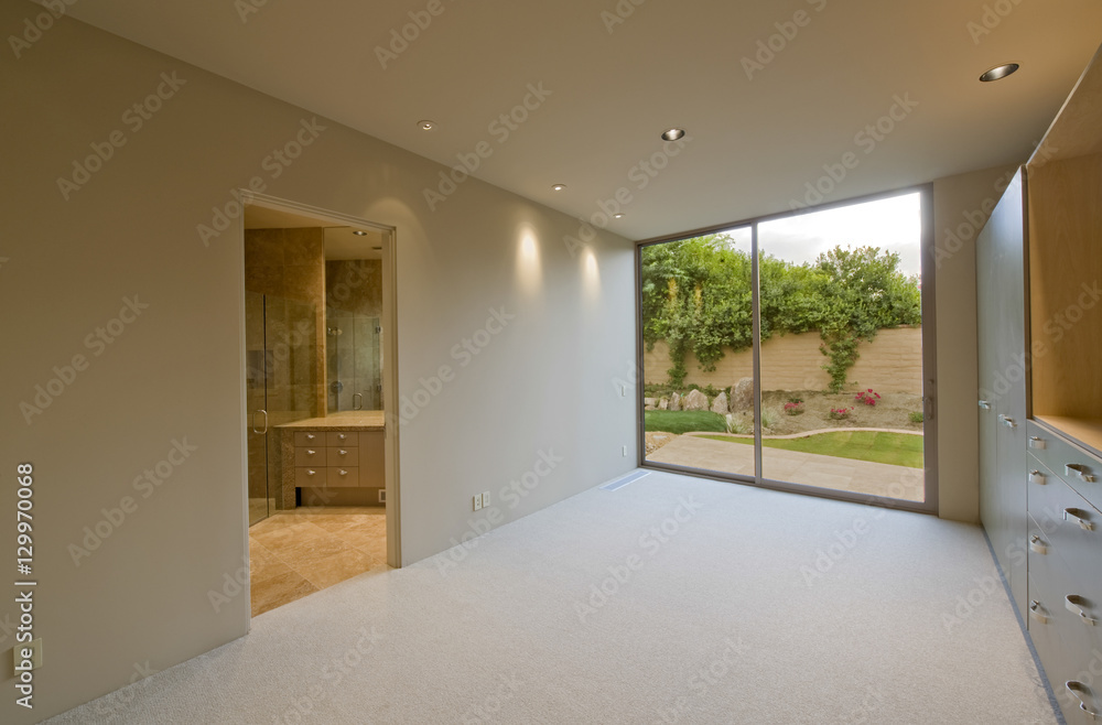 Fototapeta premium Empty room with view of porch through closed glass door