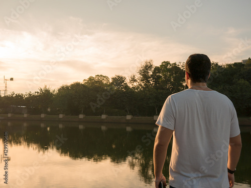 A man standing and starring at the sunrise