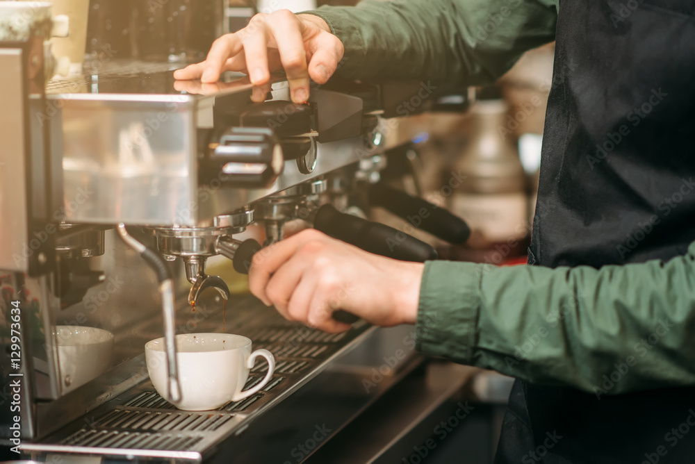 Man hands pours drink from a coffee machine. Man hands pours drink from a coffee machine.
