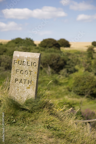 Closeup of stone sign marking public footpath