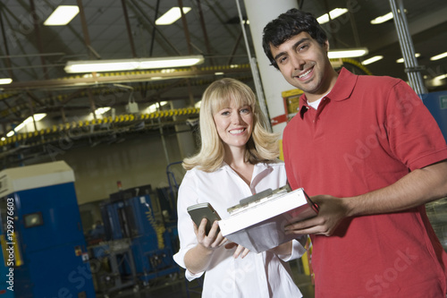 Portrait of young male and female make inventory in the newspaper factory