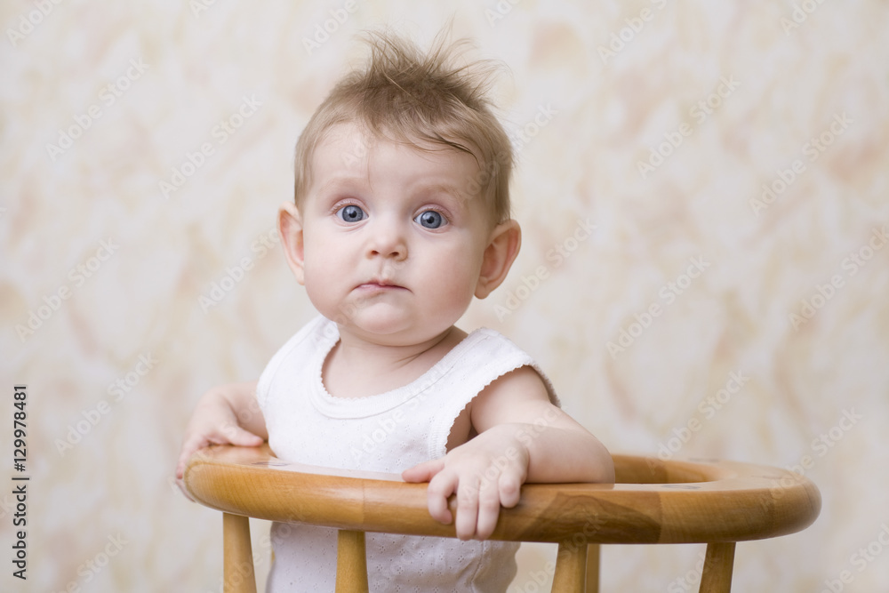 Closeup portrait of a blue eyed baby boy on high chair Closeup portrait of a blue eyed baby boy on high chair