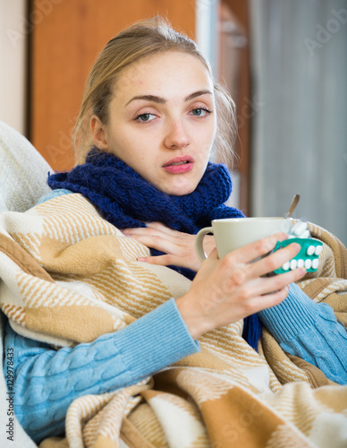 Young female having quinsy and fever and staying in couch