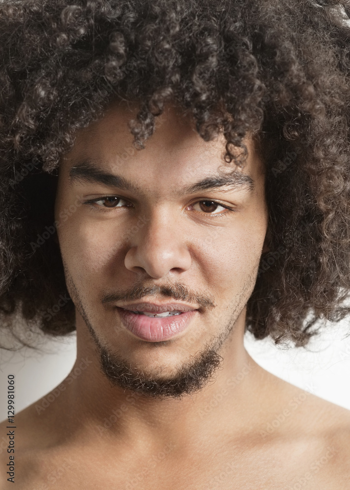 Portrait of a trendy young man with curly hair over white background Portrait of a trendy young man with curly hair over white background