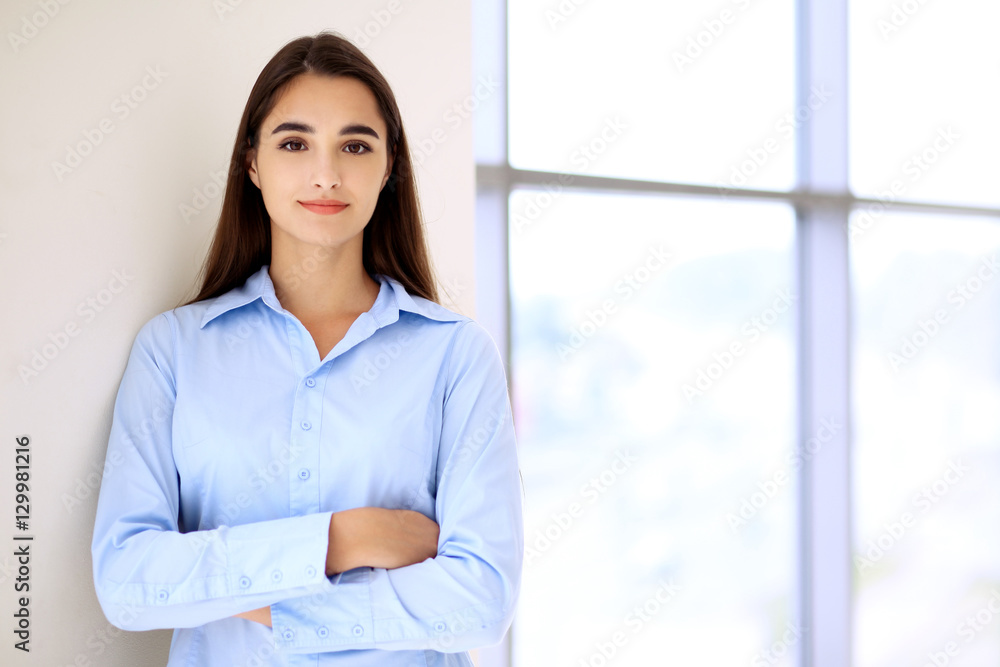 Young brunette businesswoman or student girl looking at camera