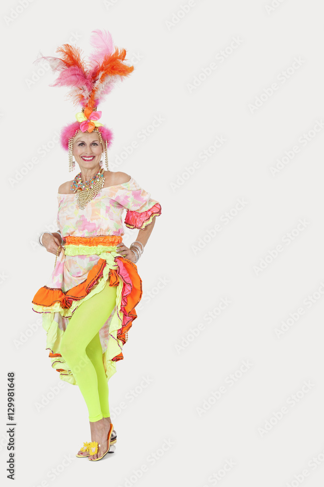 Portrait of happy senior woman in Brazilian outfit against gray background Portrait of happy senior woman in Brazilian outfit against gray background