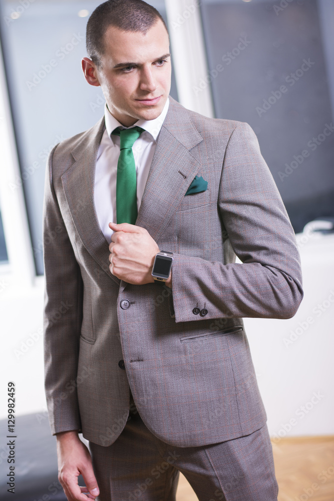 Portrait of a confident young businessman standing. Portrait of a confident young businessman standing.