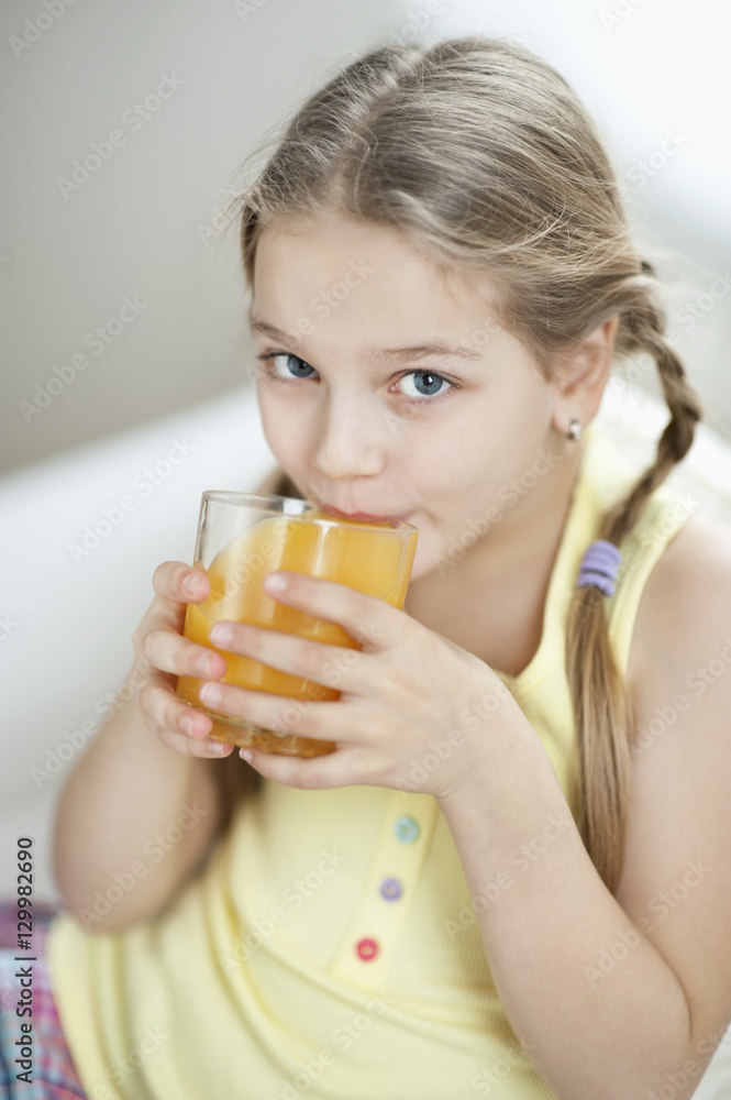 Portrait of little girl drinking orange juice Portrait of little girl drinking orange juice