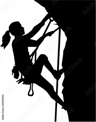 Fototapeta Female climber silhouette in ropes an a rock