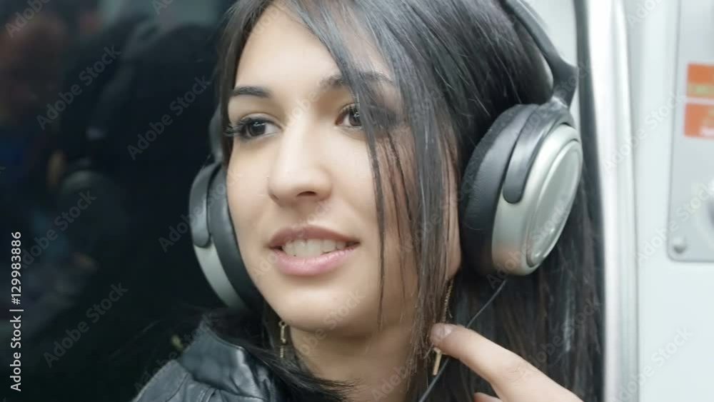 young woman relaxing with the music in the subway young woman relaxing with the music in the subway