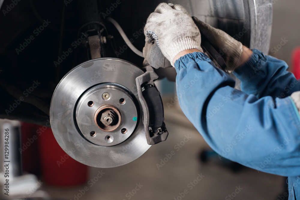 change the old drive to the Brand new brake disc on car in a garage. Auto mechanic repairing . change the old drive to the Brand new brake disc on car in a garage. Auto mechanic repairing .