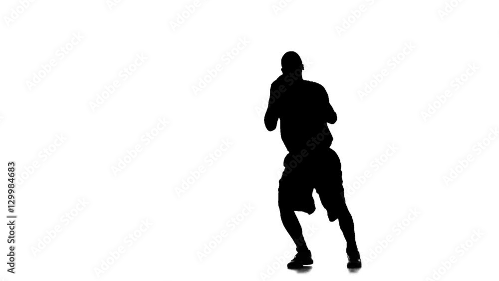 Basketball player jumps up and throws the ball up. White background Basketball player jumps up and throws the ball up. White background