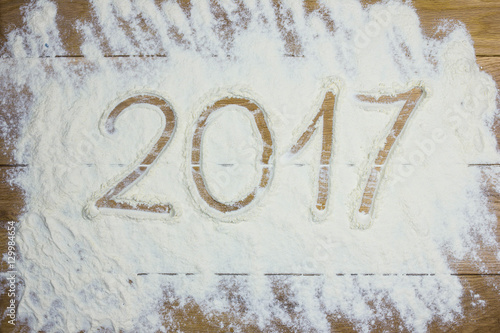 Happy new 2017 year on the flour, wooden background