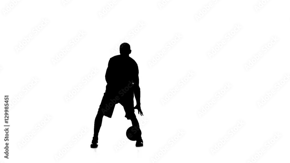 Basketball feint passes the ball. Silhouette. Slow motion. White background. Basketball feint passes the ball. Silhouette. Slow motion. White background.