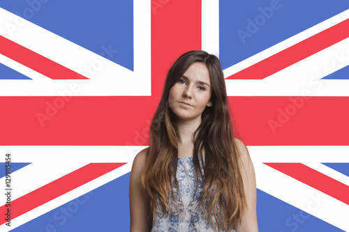 Portrait of young woman against British flag