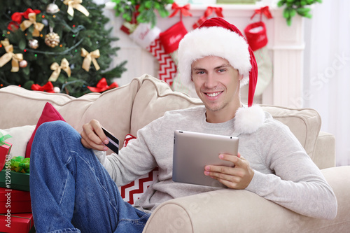 Young man shopping online w...