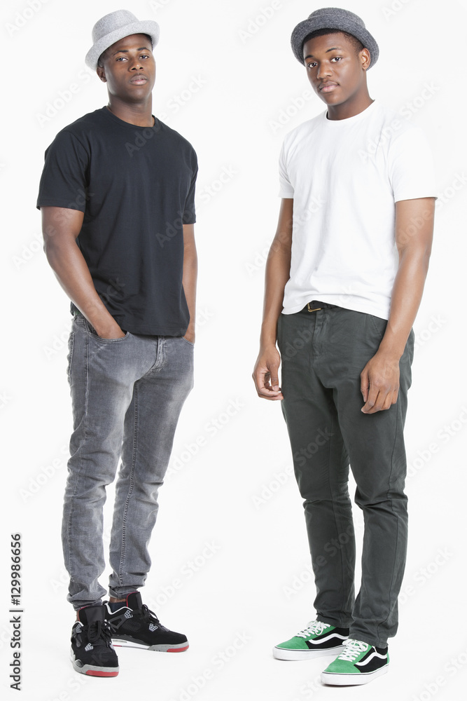 Portrait of two young African American men in casuals over gray background Portrait of two young African American men in casuals over gray background