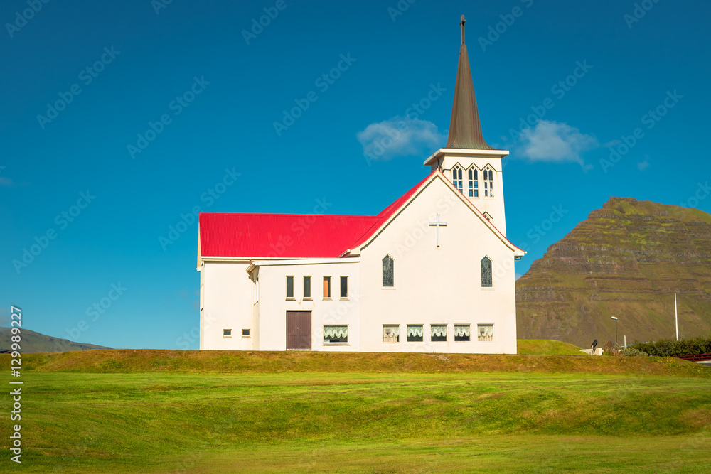 Lonely Church illuminated by sun at Iceland, summer time