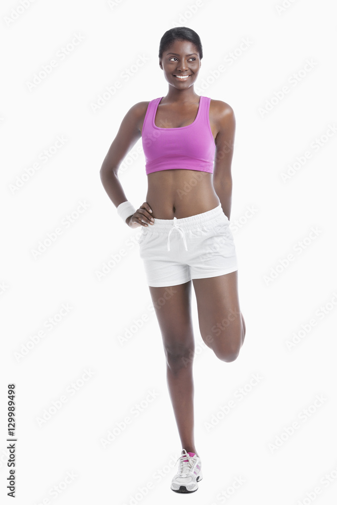 Young African American woman exercising over white background Young African American woman exercising over white background