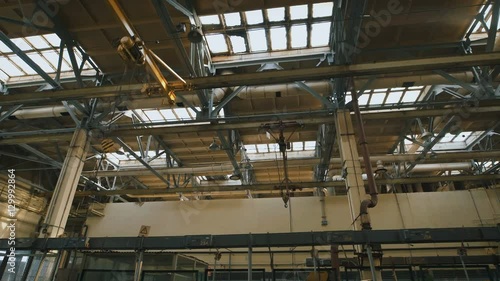 Wallpaper Mural Production premise with a high ceiling. Many metal structures, ventilation pipes used in building construction. Big light windows in the roof are used for lighting in the daytime. Torontodigital.ca