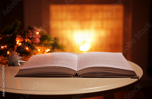 Open book on table against blurred background