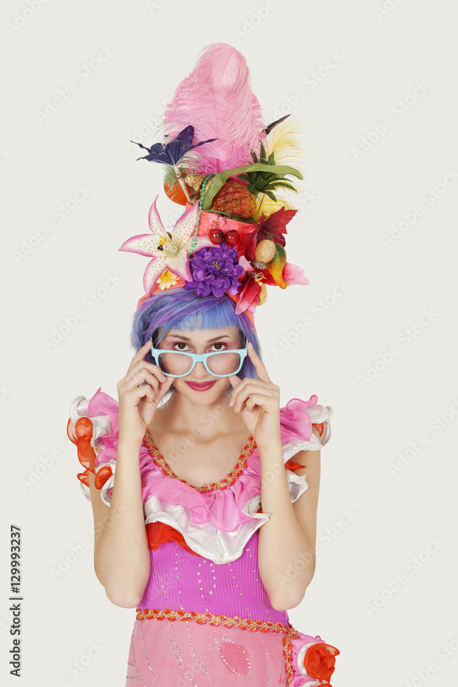 Portrait of beautiful young woman in Brazilian outfit over gray background Portrait of beautiful young woman in Brazilian outfit over gray background