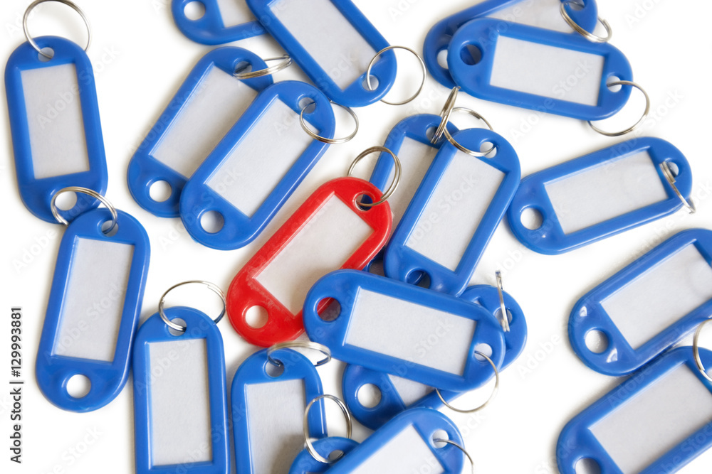 Red tag ring with blue key rings over colored background