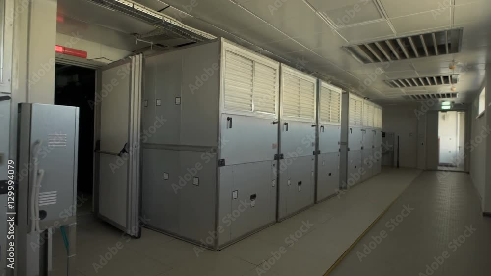 Camera moves along the corridor where there are large wardrobes in which industrial air filters are placed. In the room on the ceiling has holes for ventilation. Camera moves along the corridor where there are large wardrobes in which industrial air filters are placed. In the room on the ceiling has holes for ventilation.