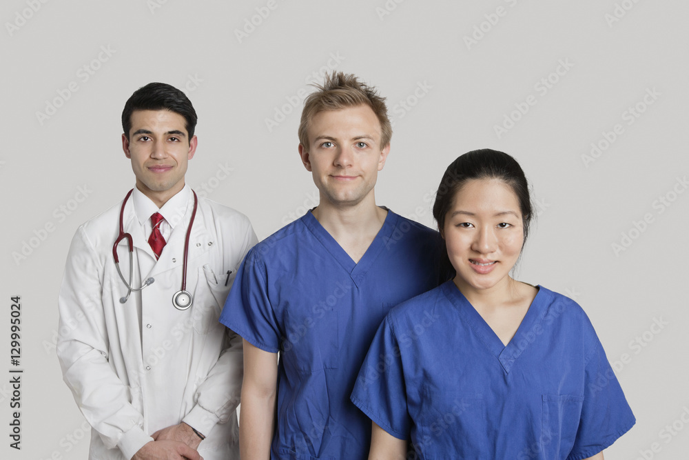 Portrait of happy medical team standing over gray background Portrait of happy medical team standing over gray background