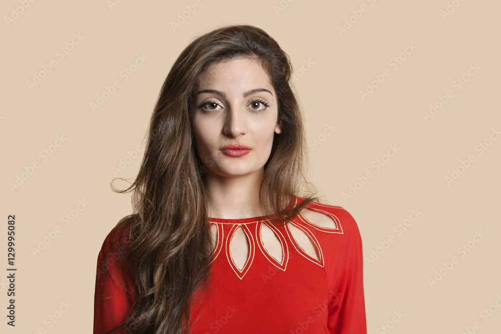 Portrait of beautiful young woman in red over colored background Portrait of beautiful young woman in red over colored background