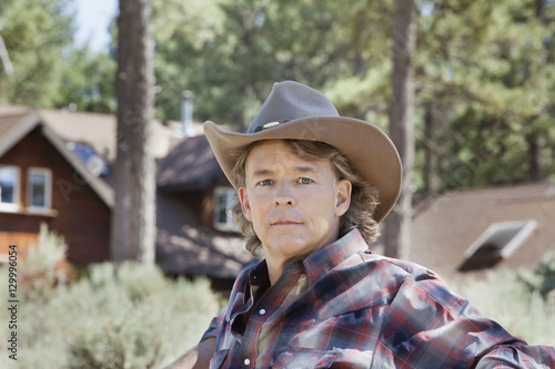 Close-up portrait of a mature man wearing cowboy hat