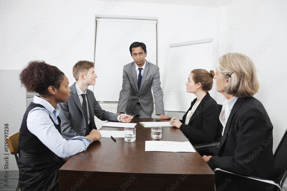Multiethnic businesspeople at meeting in conference room Multiethnic businesspeople at meeting in conference room