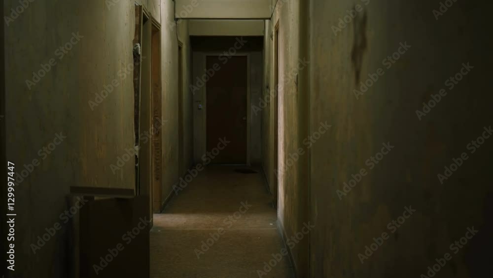 Old apartment building interior with long and creepy dark hallway. Old apartment building interior with long and creepy dark hallway.