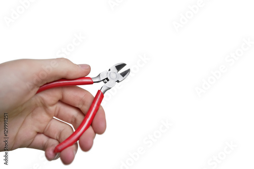 Cropped image of hand holding pliers over white background