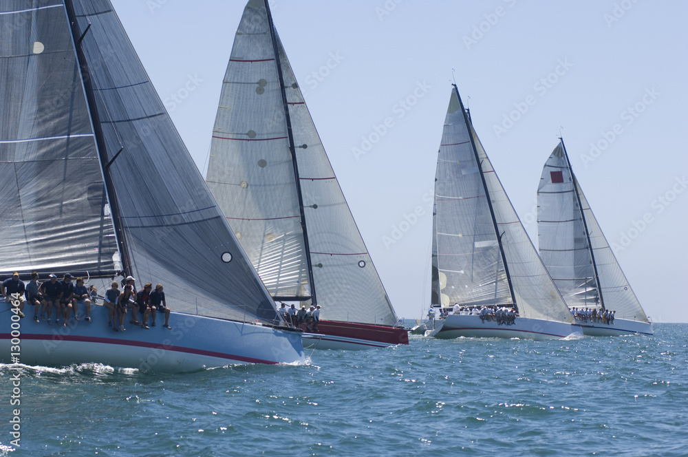 View of four yachts competing in team sailing event View of four yachts competing in team sailing event