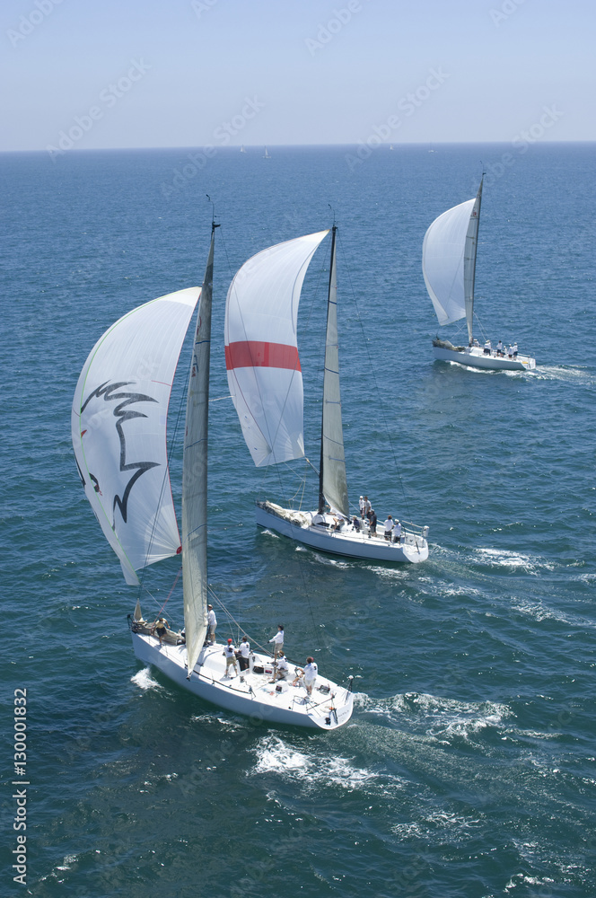 Obraz premium View of three yachts competing in team sailing event
