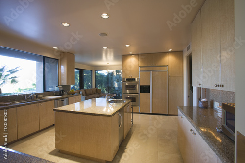 View of a spacious kitchen with island in house