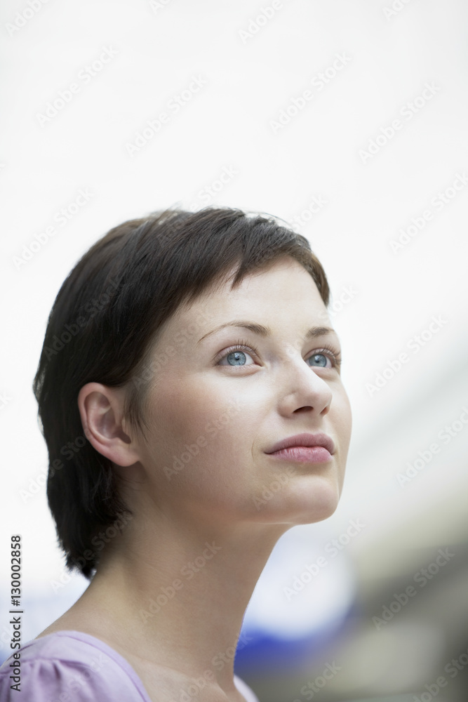Closeup of beautiful young woman looking away in shopping centre Closeup of beautiful young woman looking away in shopping centre