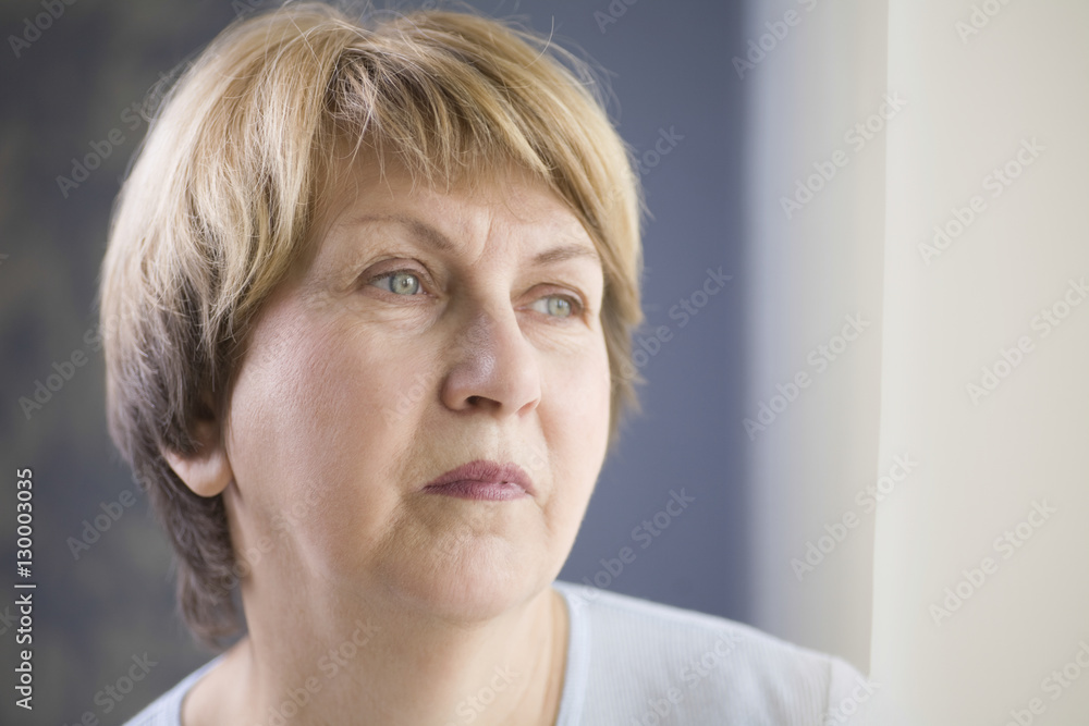 Closeup of pensive senior woman looking away at home Closeup of pensive senior woman looking away at home