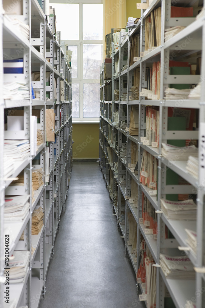 Obraz premium Aisles in university library with shelves full of books