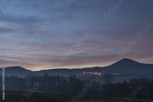 Sunrise under Milesovka hill in winter